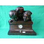 Bronze effect mantel clock with 3 figure heads with inscription to base "Curiosette"