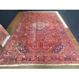 Iranian carpet, red ground all over geometric pattern with border 375cmx251cm