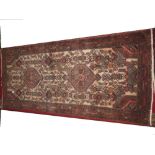 Hamadan rug, beige ground with all over stylised motif within a red ground border