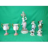 Pair of continental porcelain figure groups with children aloft, pair of porcelain figurines, a