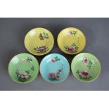 Five C18th Chinese famille rose sgraffito ground dishes, two in yellow, two in green and one in