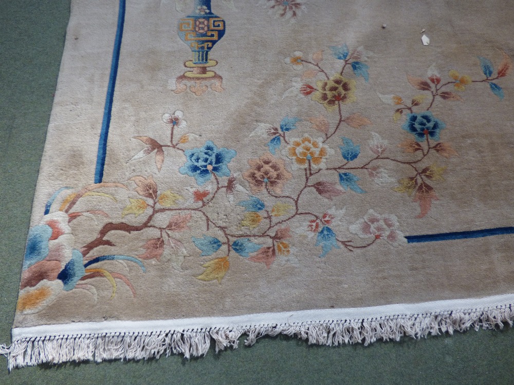 Washed Chinese carpet fawn ground decorated with branches within blue band 355 cm x 260 cm - Image 2 of 2