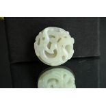 Chinese white jade archaistic ‘Bi’ disc, carved on one side in high relief with chilong, and the