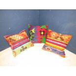 Three bright coloured kilim cushions