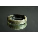 Chinese green and black jade bangle carved with calligraphy around the sides, Ming Dynasty, 7.8cm