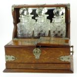 19th Century Bronze Mounted Oak Tantalus with Cut Glass Decanters. Unsigned. Rubbing to bronze