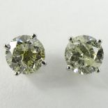 AIG Certified 1.41 Carat Total Weight Round Cut Diamond and 14 Karat White Gold Ear Studs.