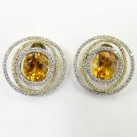 Pair of Oval Cut Citrine and 18 Karat Yellow and White Gold Earrings accented with small round cut