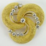 Vintage 18 Karat Yellow Gold and Approx. 1.20 Carat Round Cut Diamond swirl Brooch. Diamonds F-G