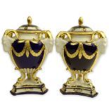 Pair Royal Dux Porcelain Cobalt and Parcel Gilt Covered Urns. Ram's head handles. Signed. Light wear