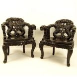 Pair of 20th Century Chinese Carved Wood Dragon Arm Chairs. Inset eyes. Unsigned. Rubbing, minor