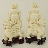 Pair of Vintage well carved Ivory Foo Lion Urns on Hardwood Stands. Unsigned. Age cracks or in