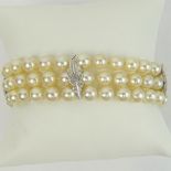 Vintage Three Strand Pearl and 14 Karat White Gold Bracelet. Signed 14K. Pearls measure 6mm.