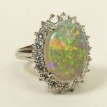 Lady's Oval Cut White Opal, Approx. 1.0 Carat Round Brilliant Cut Diamond and Platinum Ring. Opal