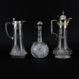 Lot of Three Cut Glass Decanters. Includes a Sterling Lidded bottle Marked Sterling, minor chips,