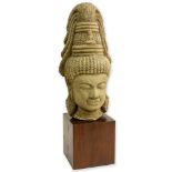 Vintage Cambodian Carved Stone Buddha Head. On wood block. Unsigned. Good condition. Measures 19-1/