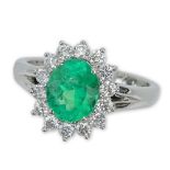 1.63 Carat Oval Cut Emerald, .65 Carat Round Brilliant Cut Diamond and 18 Karat White Gold Ring.