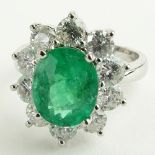 Lady's 2.40 Carat Oval Cut Emerald, 2.15 Carat Round Cut Diamond and 14 Karat White Gold Ring.