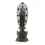 Early 20th Century Chinese Patinated Bronze Standing Buddha. Depicted standing on lotus flower. Base