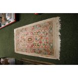 A thick-pile floor rug with geometric designs and flora against a cream ground.