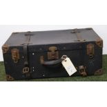 A vintage bound suitcase with metal corners and leather straps