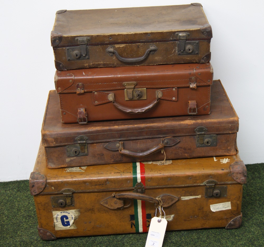 A vintage brown suitcase with shipping labels,