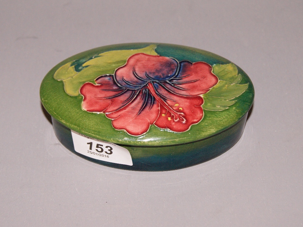 A Coral Hibiscus' oval lidded trinket pot by Moorcroft CONDITION REPORT; Available on request.