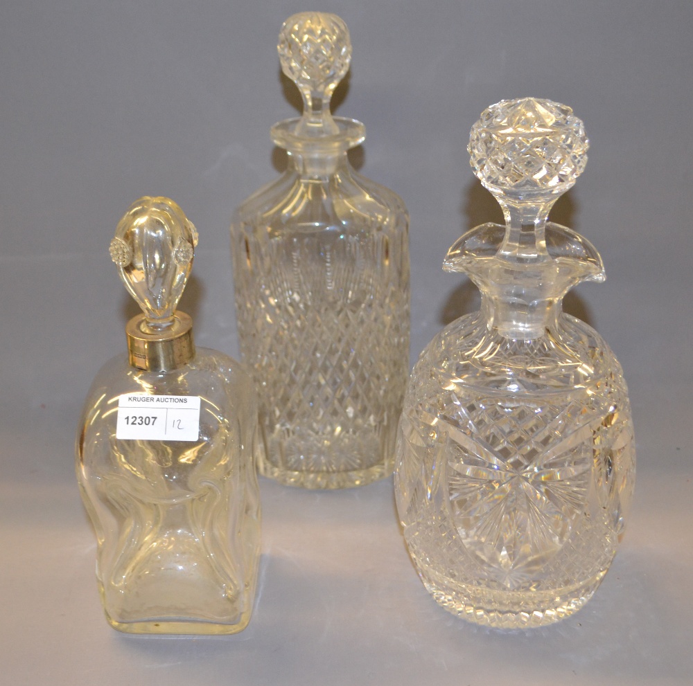 Three good-quality cut-glass decanters with their respective stoppers,