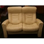 A John Lewis' reclining 'aircraft' style two seater cream leather sofa