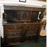 Oak panelled and carved court cupboard with hidden compartments