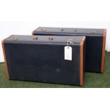 A pair of blue and tan vintage suitcases