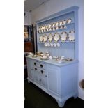 A large Victorian painted oak dresser and plate rack with a fitted interior to the base.