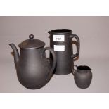 Wedgwood, a black basalt teapot and cover, a water pitcher and a cream jug CONDITION REPORT;