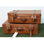 A pair of tan-leather bound suitcases
