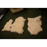 Three sheep-skin floor rugs of varying sizes CONDITION REPORT; Two of these are in good clean