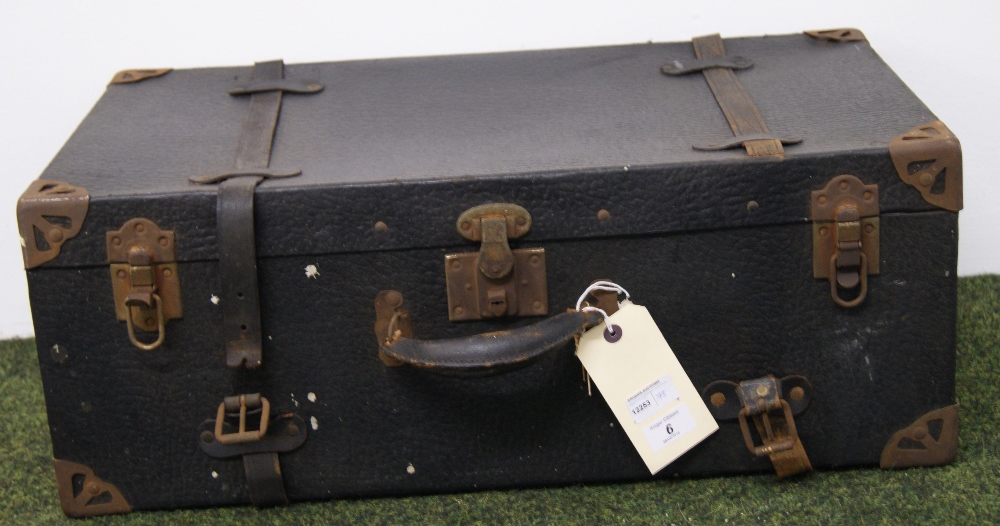 A vintage bound suitcase with metal corn