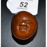 A carved coquilla - nut Netsuke,