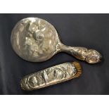 A hallmarked silver backed hand mirror and dressing brush in Reynolds Angels design