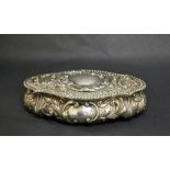 A hallmarked silver repoussé decorated trinket box, with a gilt washed interior and hinged cover.