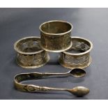 Three hallmarked-silver serviette rings and a pair of hallmarked-silver sugar-tongs Combined Weight