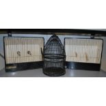 A pair of bird trap cages and another.