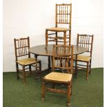 An 18th Century oak farmhouse drop leaf table with four spindle back elm chairs of the same period.