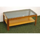 A rectangular teak coffee table by Myer with a smoked-glass top