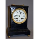 An ebonised French bracket clock having a circular enamelled dial with Roman chapters.