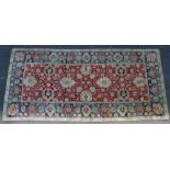 Large wool Hamadan rug with floral designs in red and blue against a cream ground. Approximately 5.