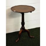A Victorian mahogany tilt-top table with a "pie crust" top, raised on a tri-pod support.