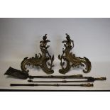 A pair of antique French ormolu fire dogs along with a set of three antique ormolu mounted fire
