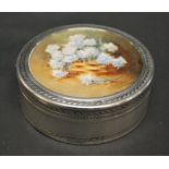 A circular French silver box, London import, 1912 with a signed miniature of flowers under glass,