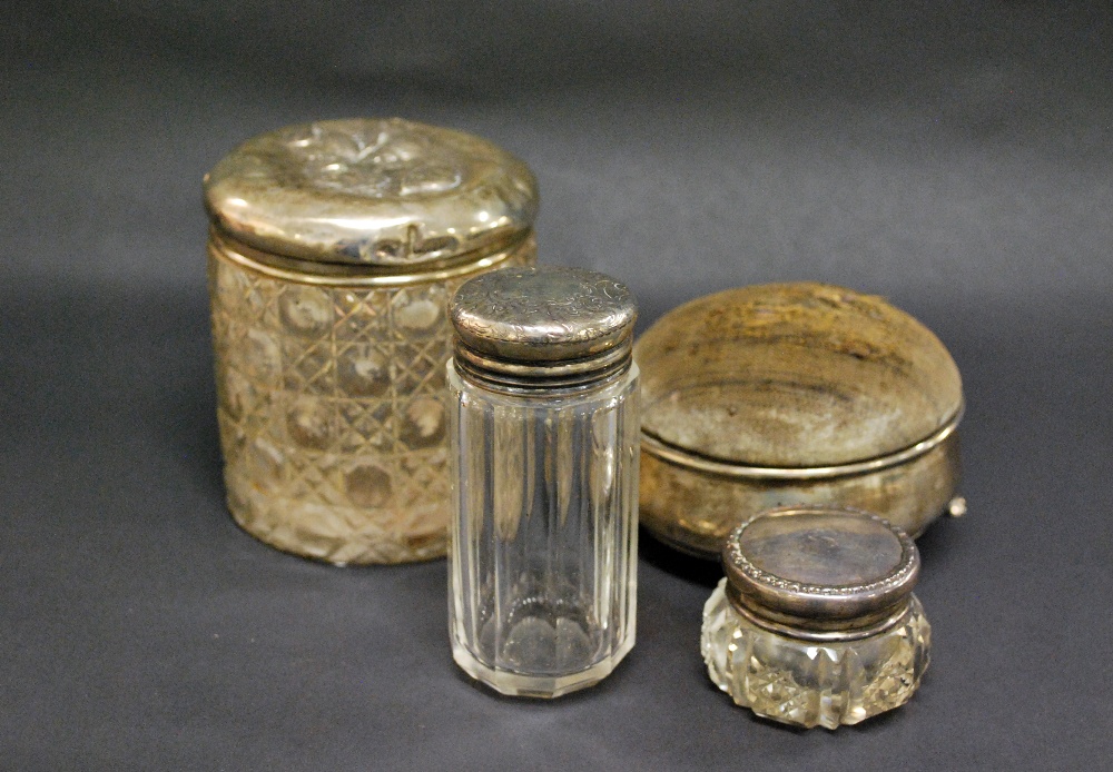 Three cut-glass dressing jars with hallmarked-silver covers (the largest with Reynolds' Angels