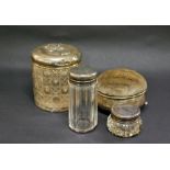 Three cut-glass dressing jars with hallmarked-silver covers (the largest with Reynolds' Angels